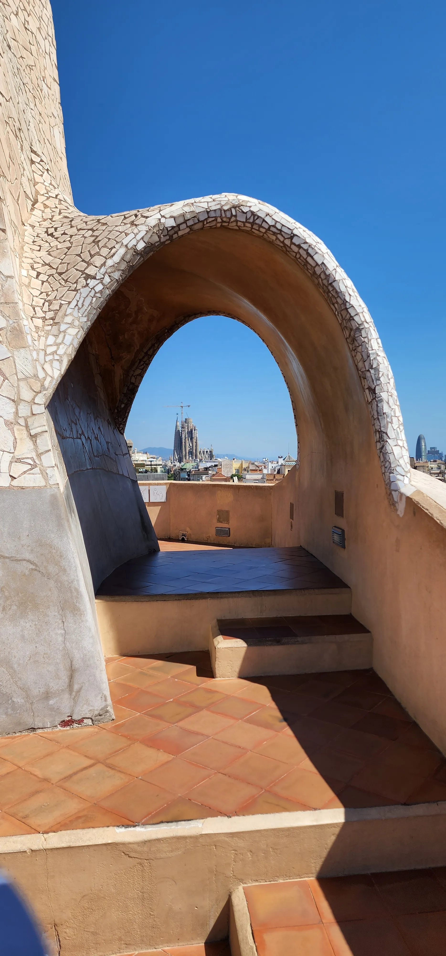 The sculptural rooftop of Casa Milà against a clean sky in Barcelona